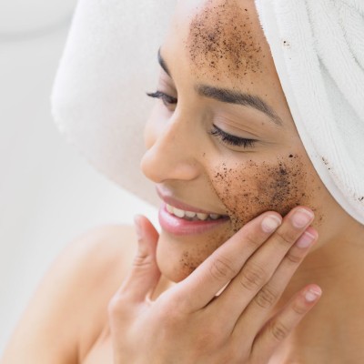 A woman putting on a face mask