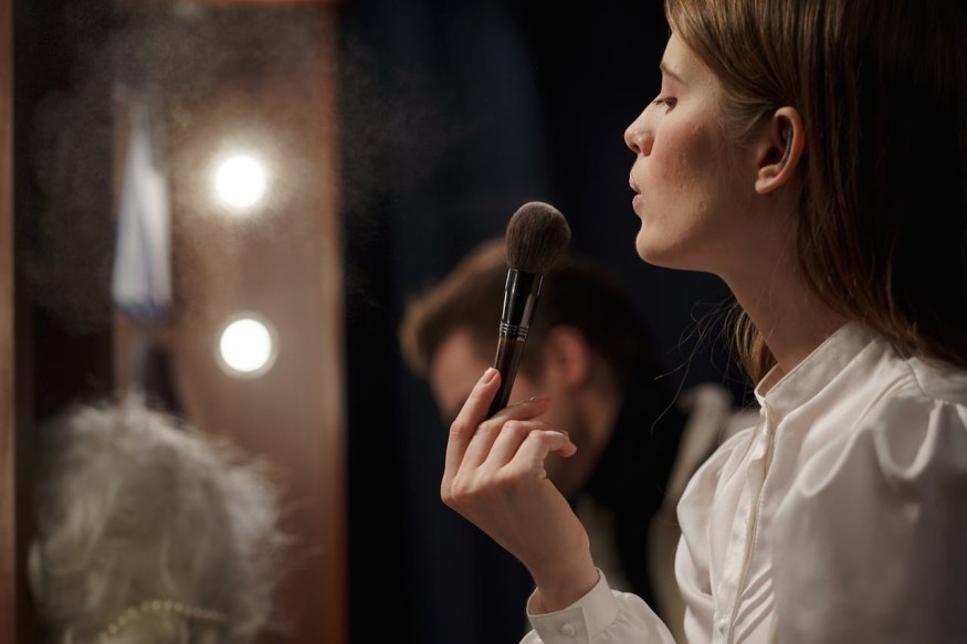 Woman in White Shirt Holding Makeup Brush