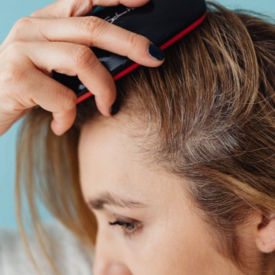 A Close-up Shot of a Woman Brushing Her Hair
