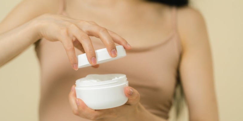 Woman opening cosmetic container