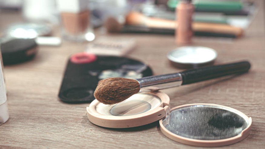 Close-up of Makeup Brushes and Compact Powder