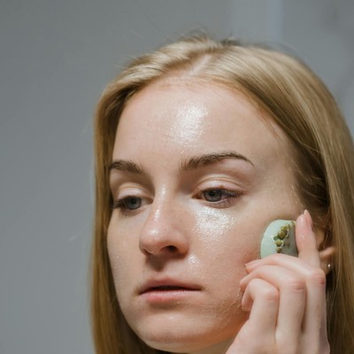 Woman Using A Beauty Product On Her Face