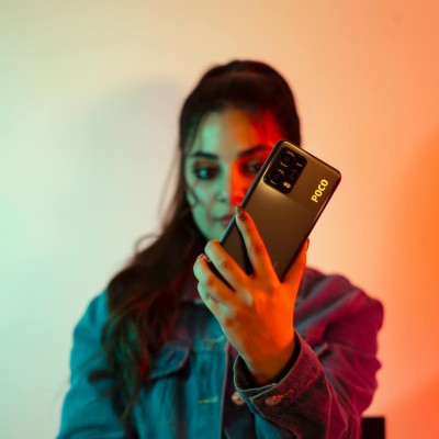 Pretty Woman Holding POCO Smartphone in Hand