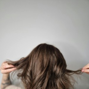 Person Holding Hair in Hands