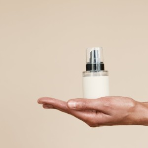 A Close-Up Shot of a Person Holding a Perfume Bottle