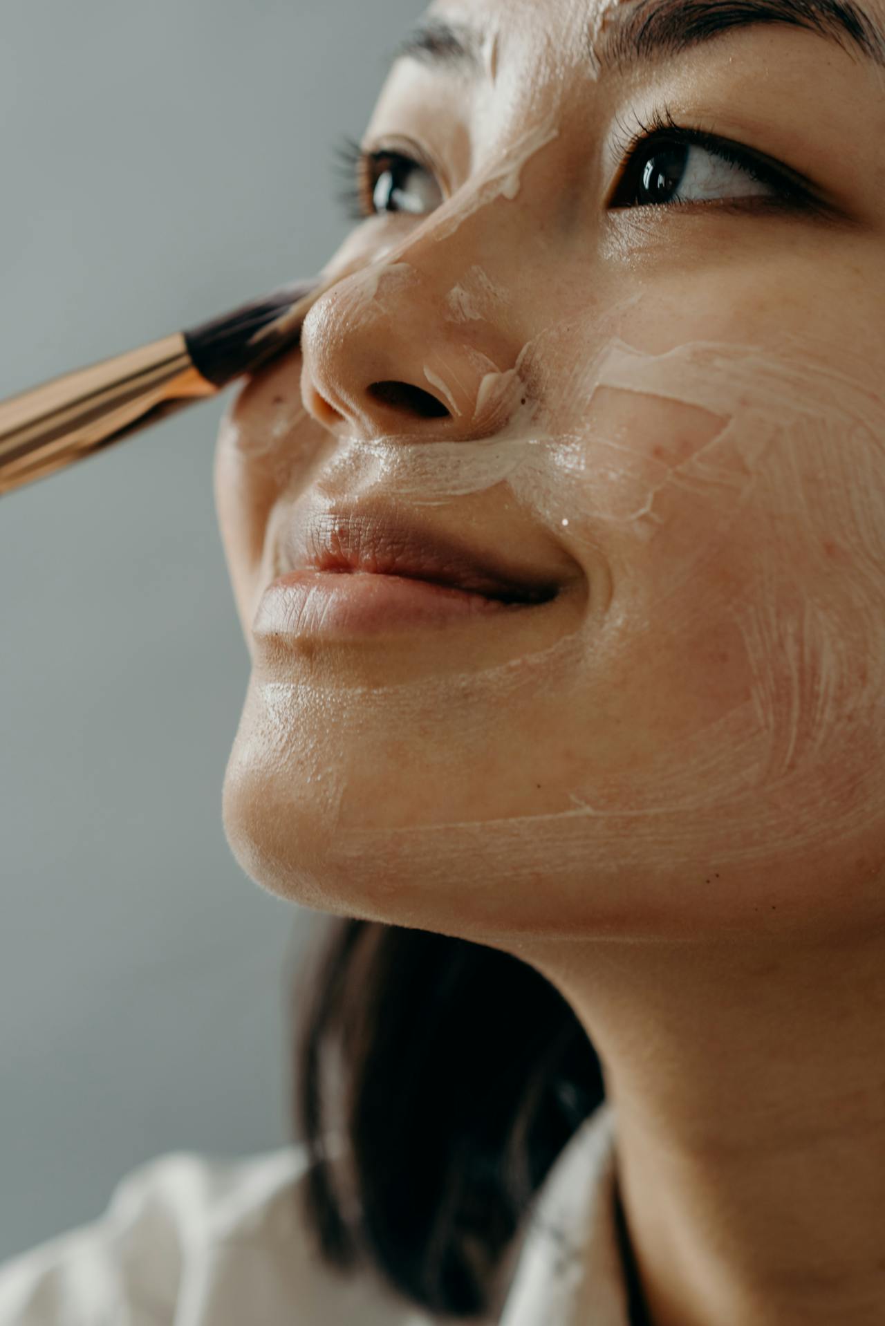 A Close-up Shot of a Woman Applying a Cream on 
