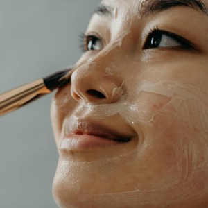 A Close-up Shot of a Woman Applying a Cream on