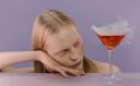 A woman with a glass of cocktail