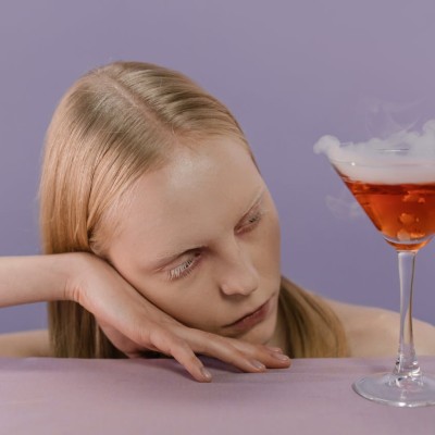 A woman with a glass of cocktail