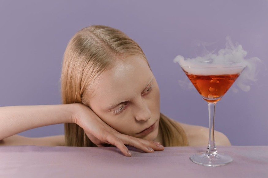 A woman with a glass of cocktail