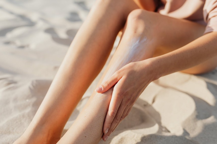 A woman applying sunscreen