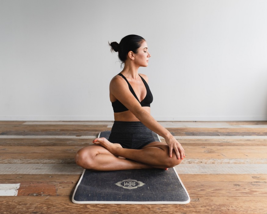 girl on yoga mat stretching