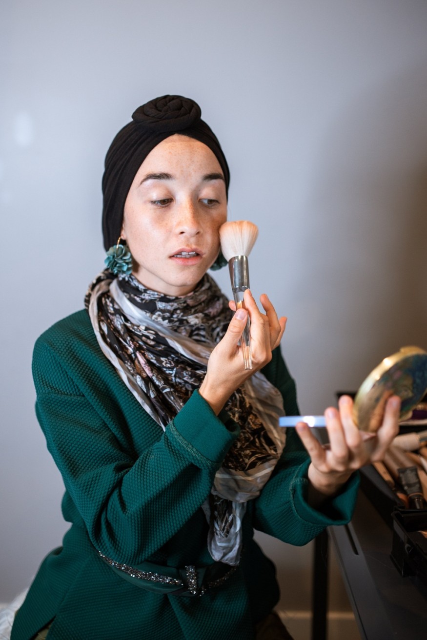Woman applying blush