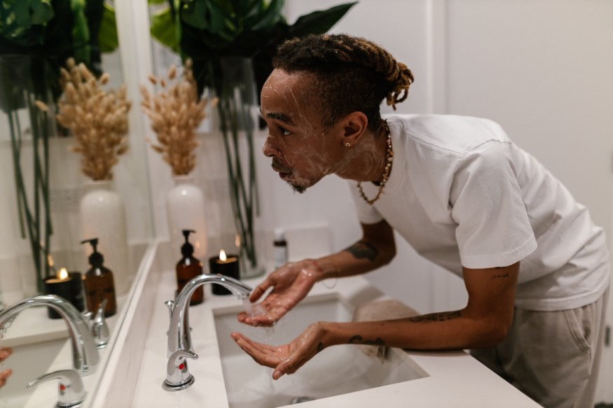 black man washing his face