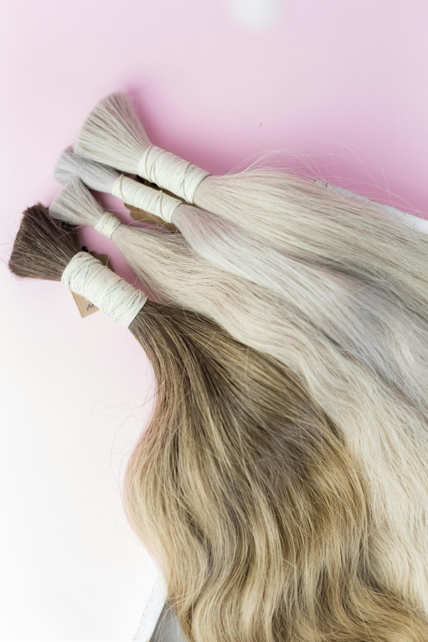 three blonde and one brunette hair extension