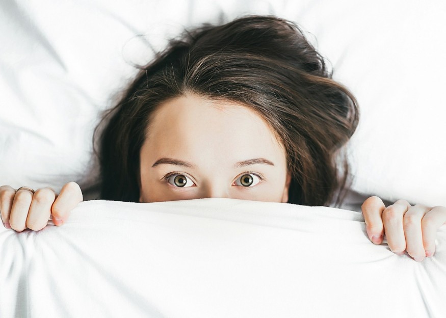 woman peak out blanket