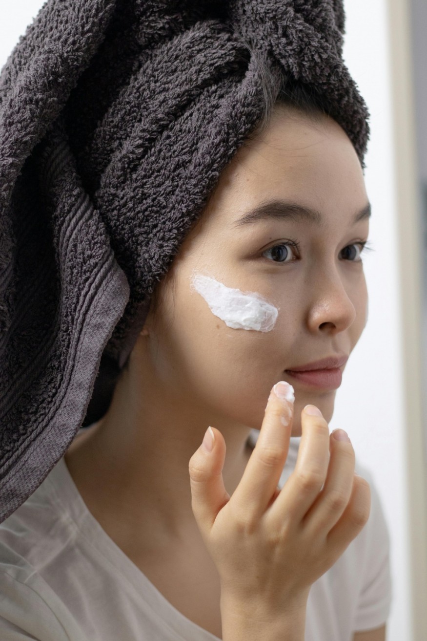 Woman applying skincare